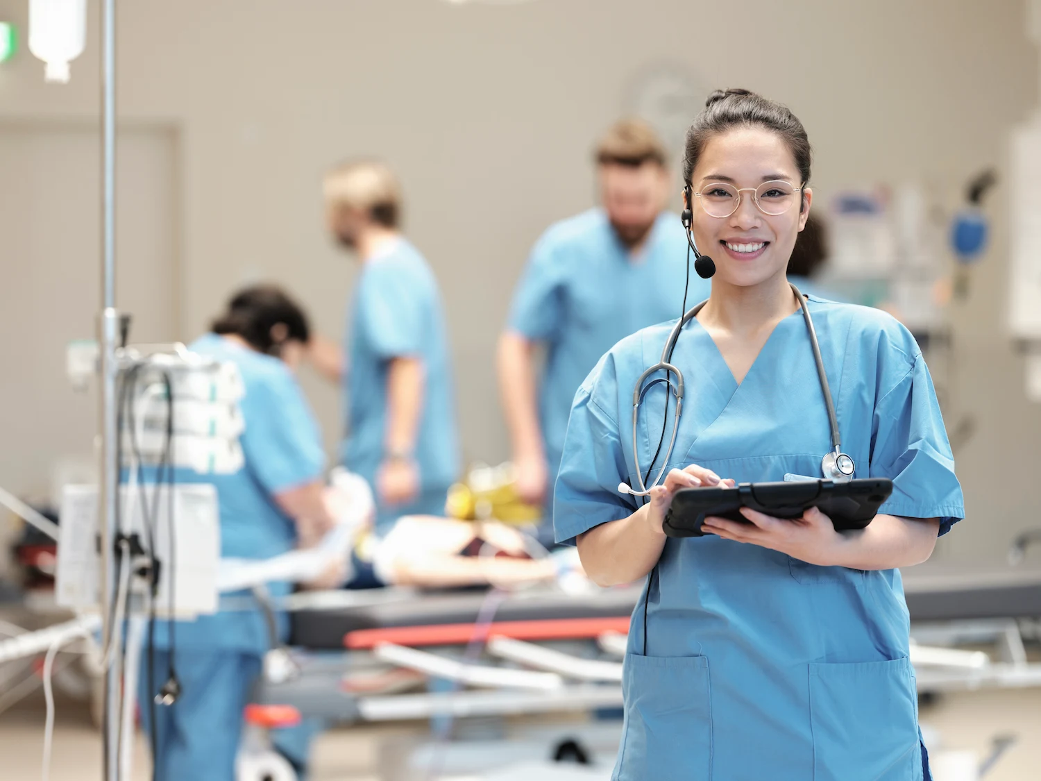 SIMStation healthcare simulation training – medical team in hospital emergency room using AV technology for patient care and professional collaboration.